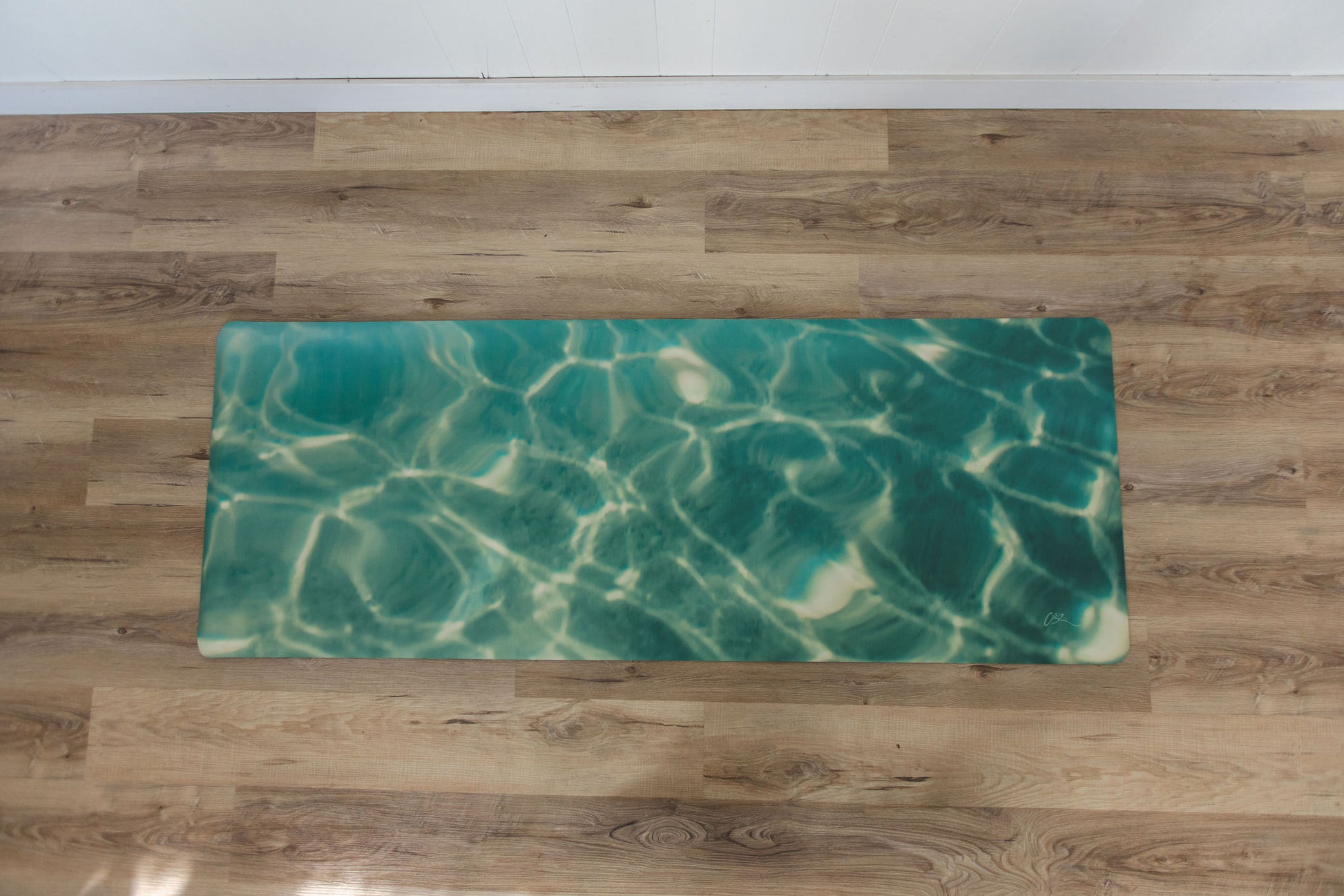 Yoga mat with water pattern on a wooden floor