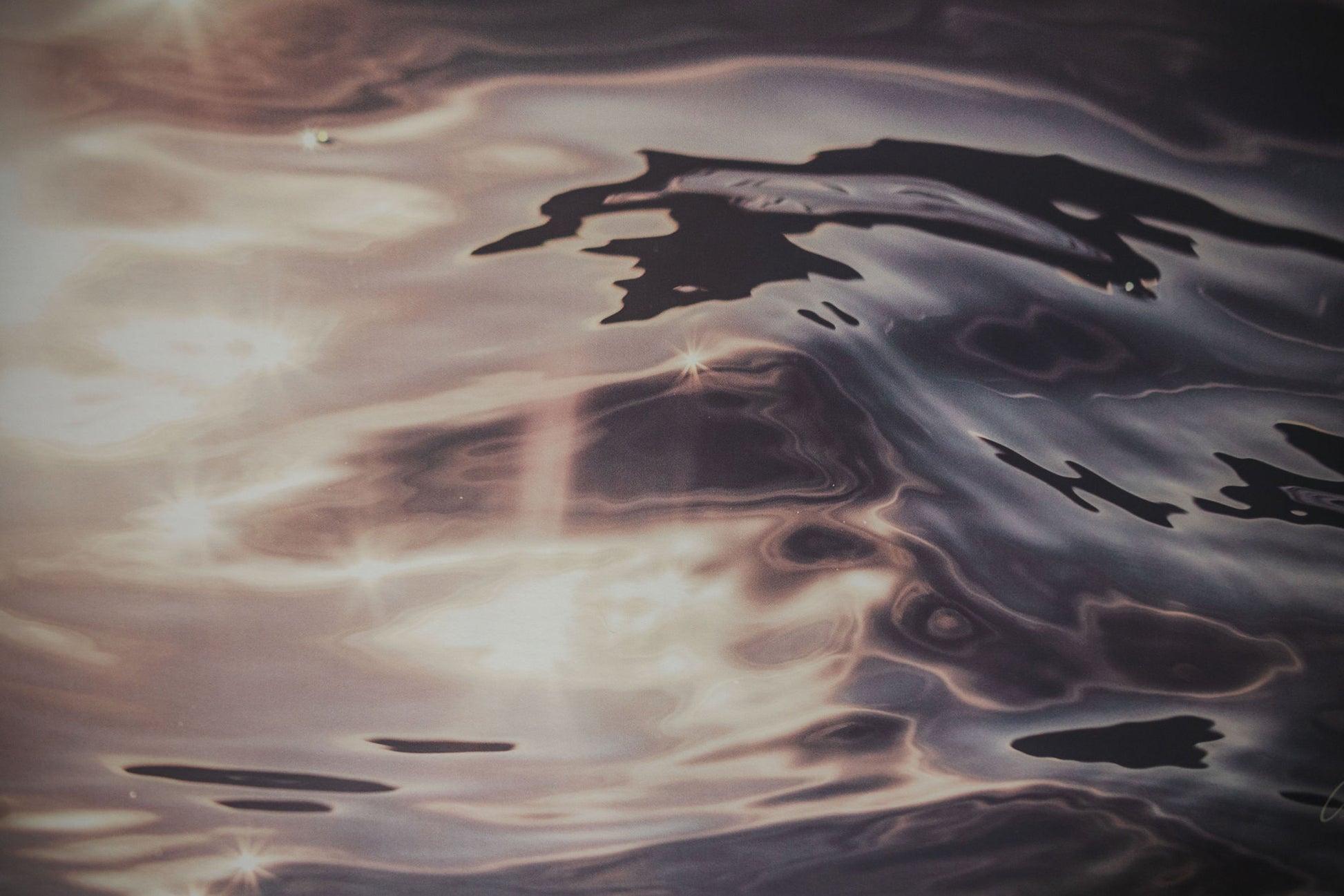 Ripples on water surface with reflections of light