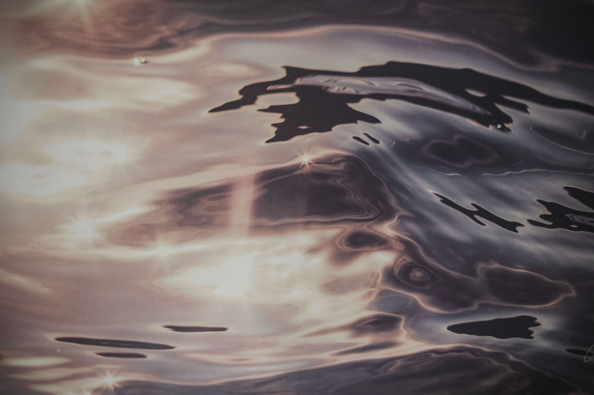 Ripples on water surface with reflections of light