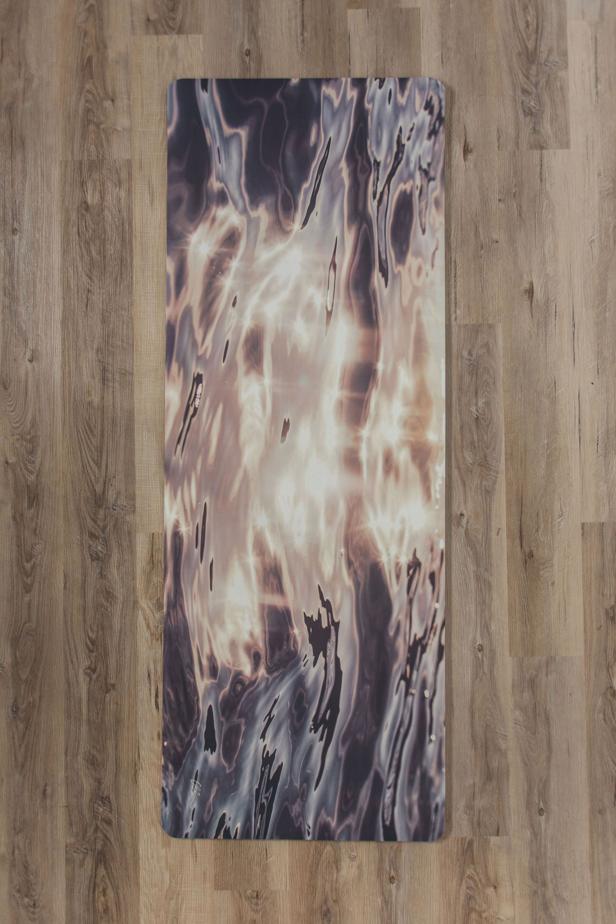 Yoga mat with abstract design on a wooden floor