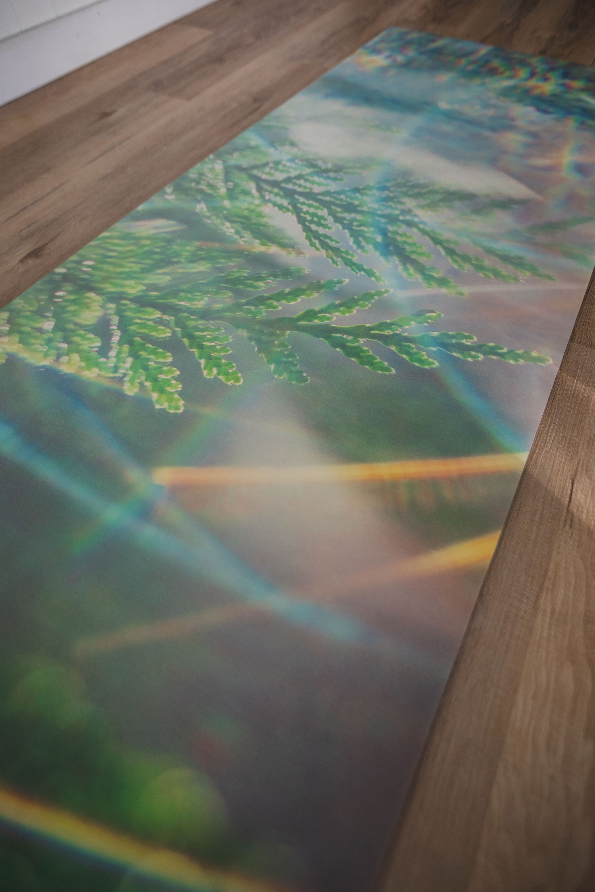 Yoga mat with nature design on a wooden floor