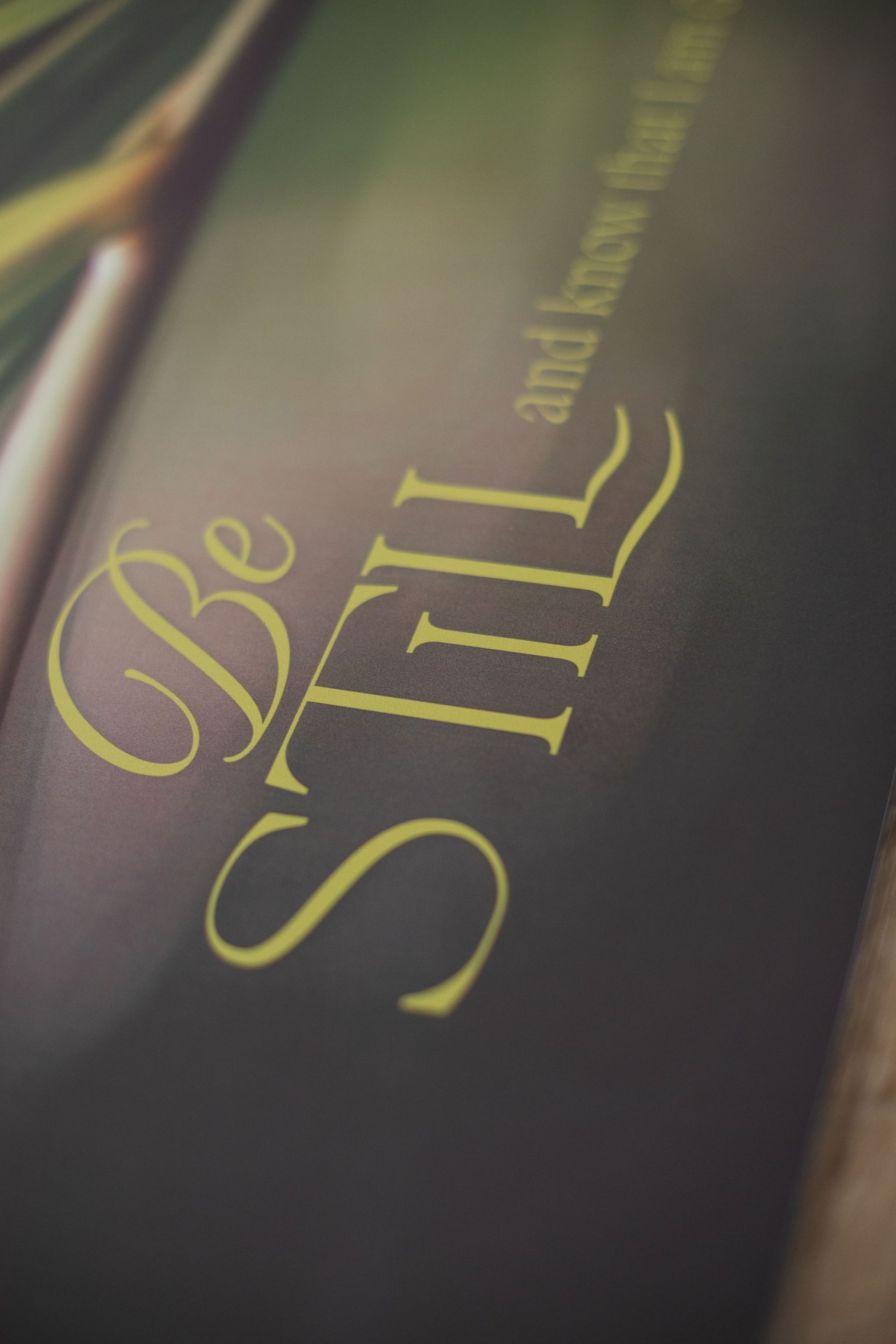 Dark background with 'Be Still' text in gold
natural fitness folding yoga mat