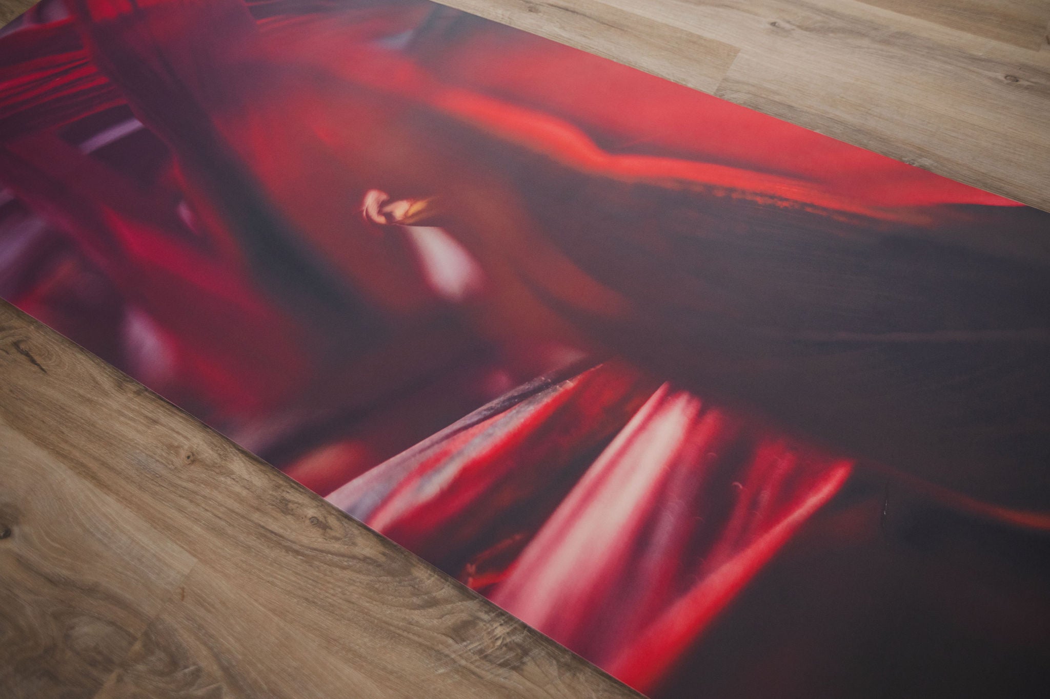 Yoga mat with artistic design on a wooden floor