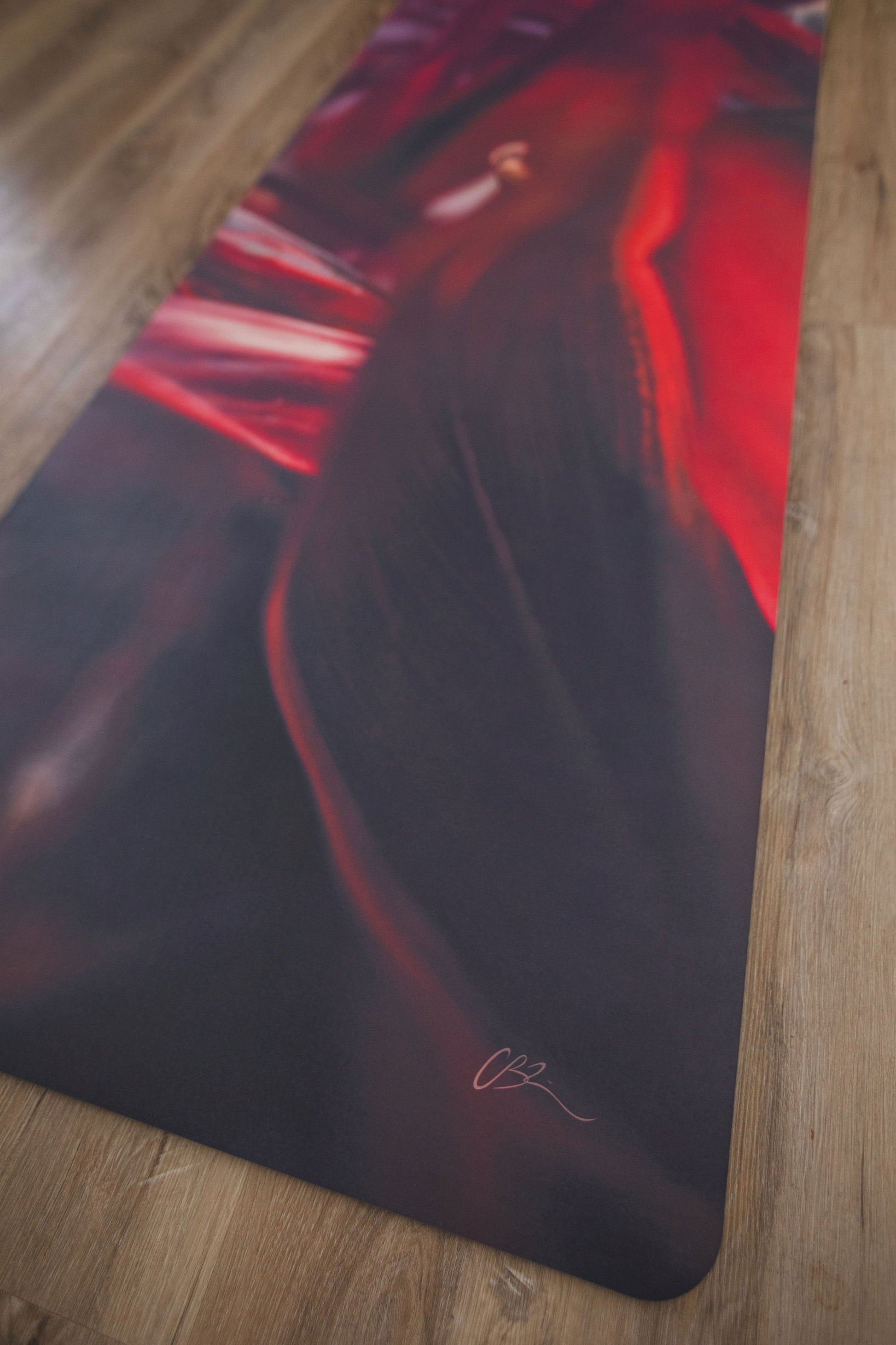 Yoga mat with artistic design on a wooden floor