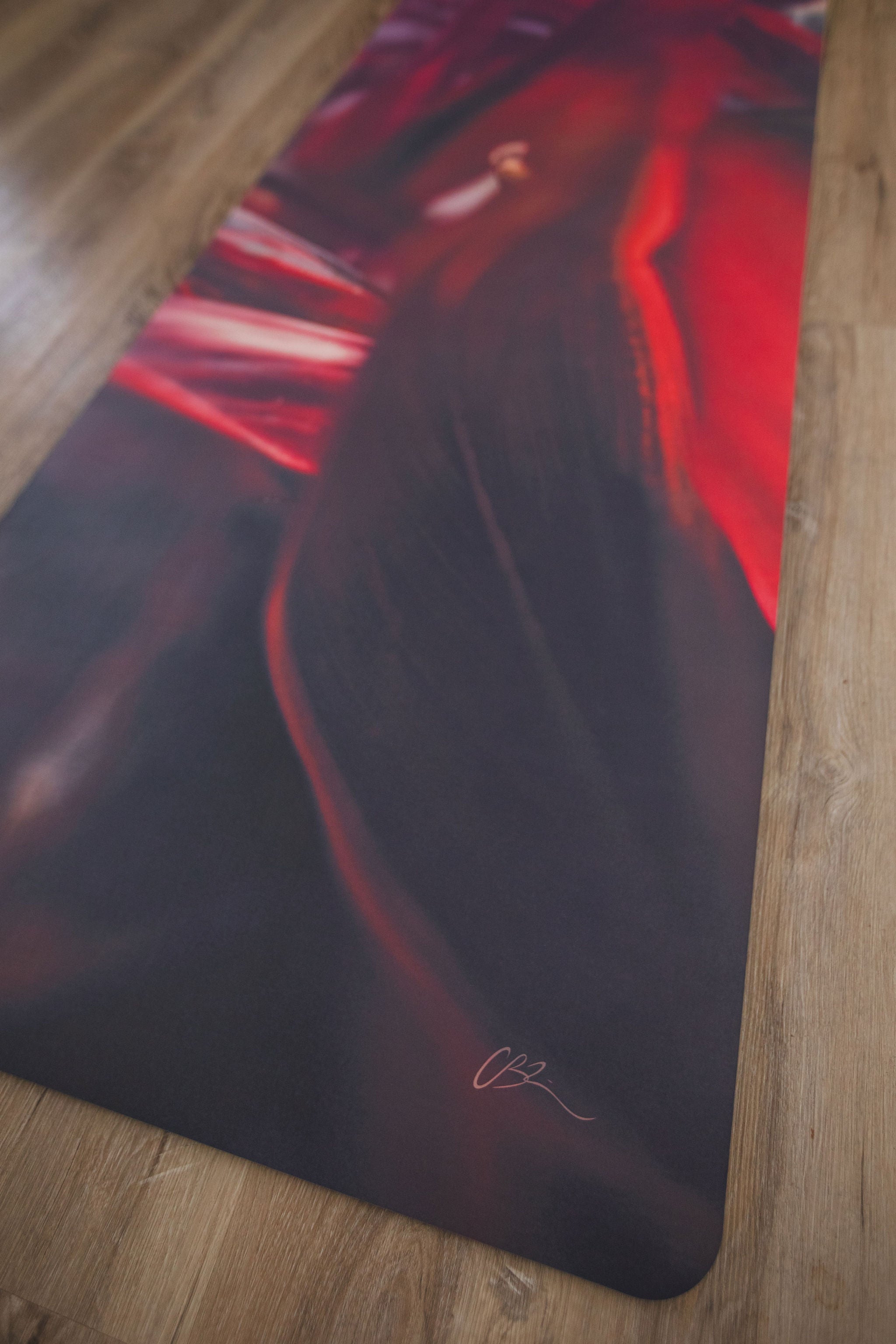 Yoga mat with artistic design on a wooden floor