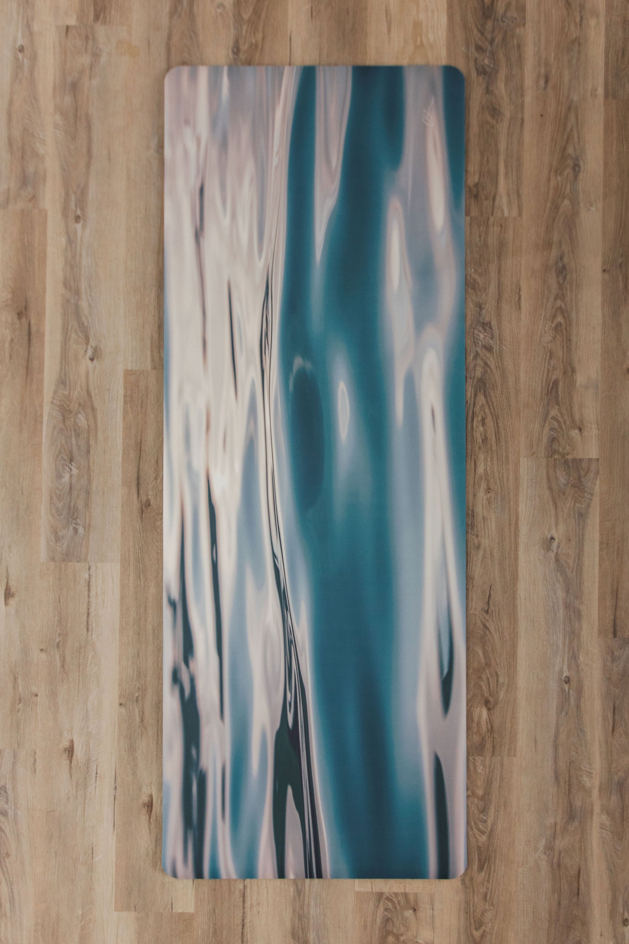 Yoga mat with abstract design on a wooden floor