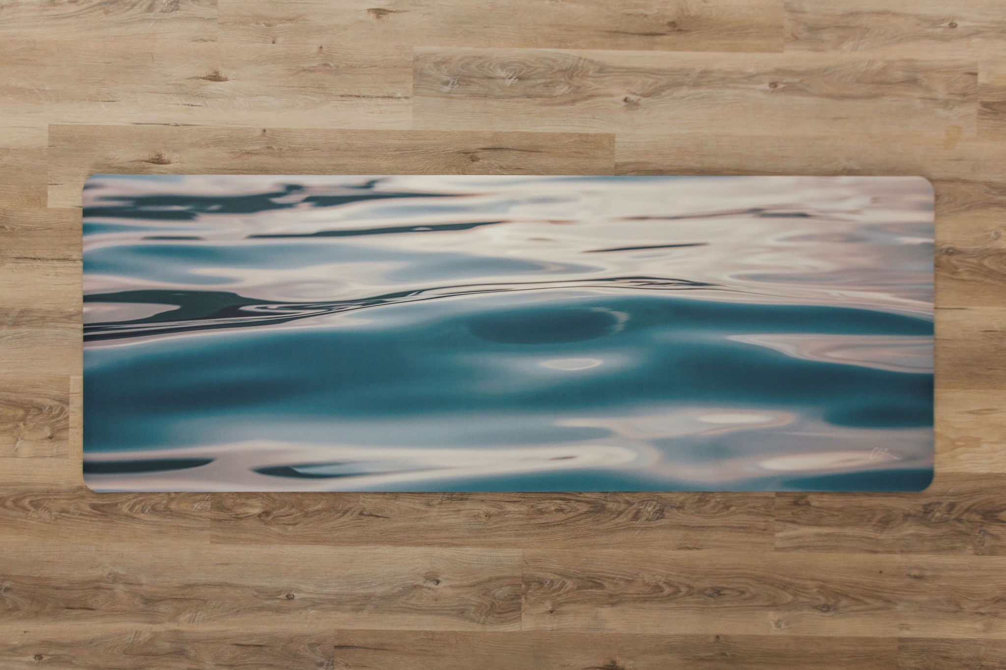 Yoga mat with water pattern on a wooden floor