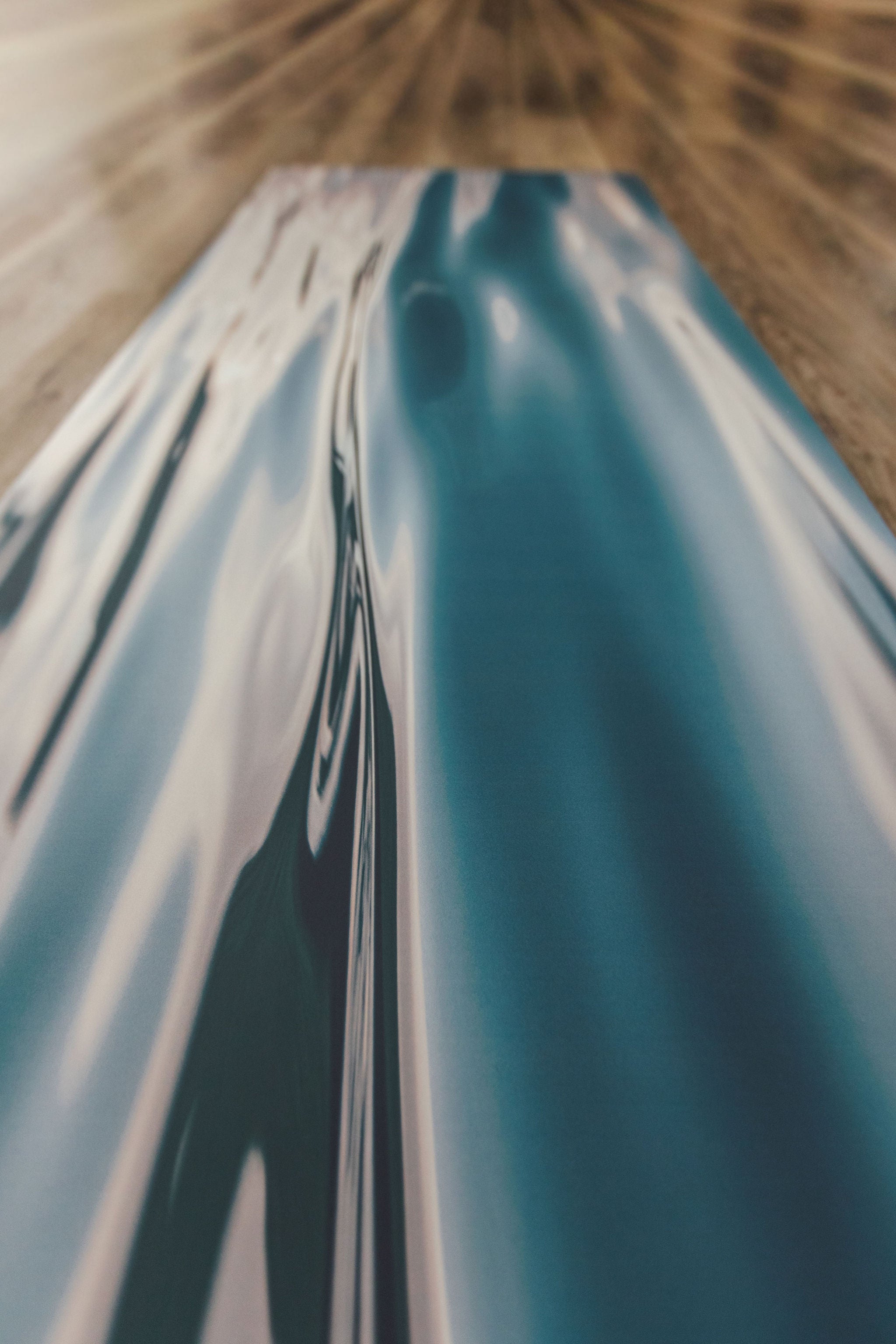 Yoga mat with water pattern on a wooden floor