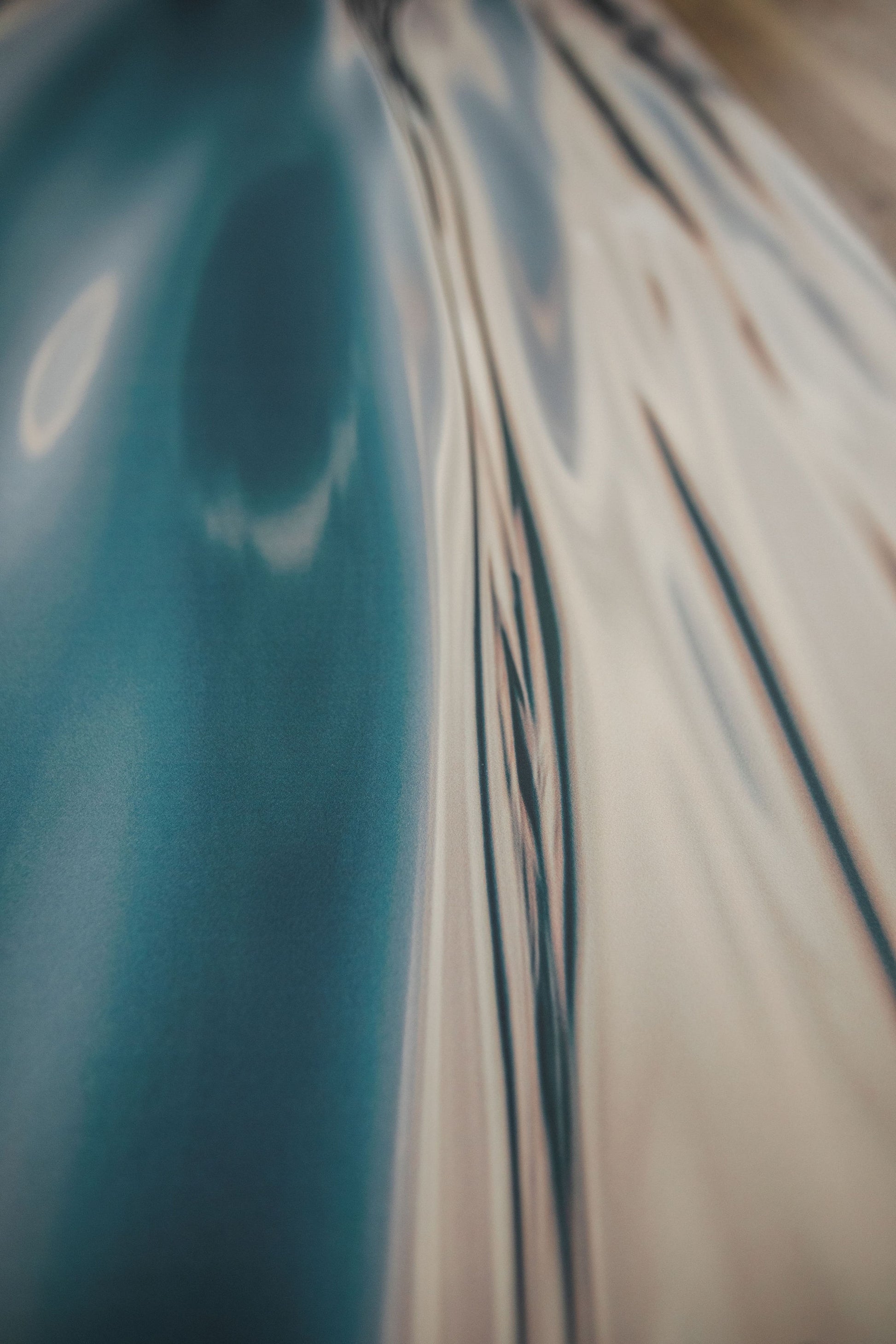Close-up of a car's reflective surface with blurred background
