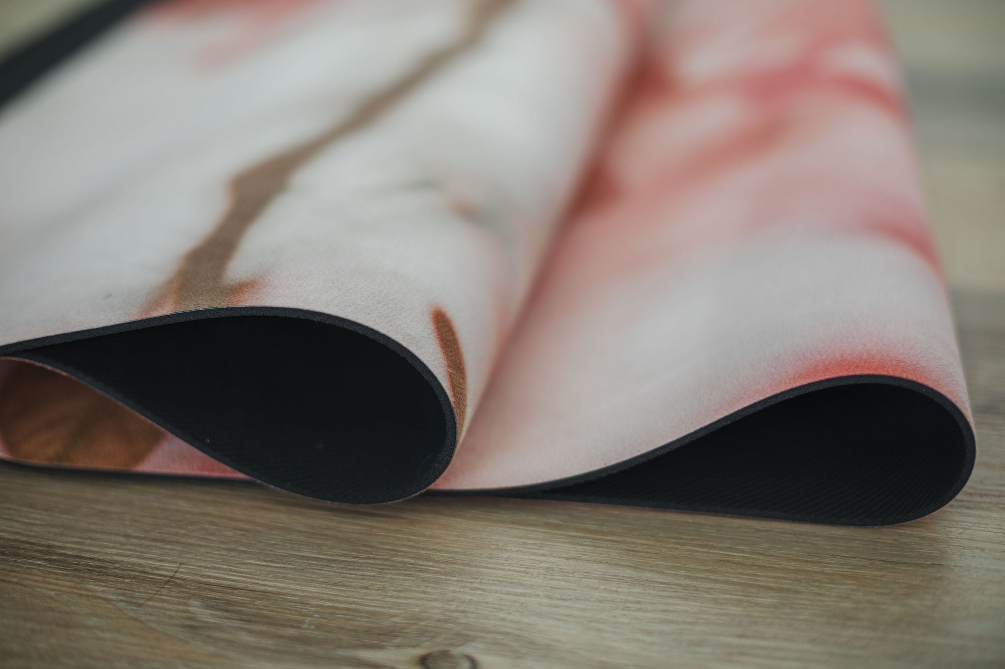 Yoga mat with a floral pattern on a wooden surface