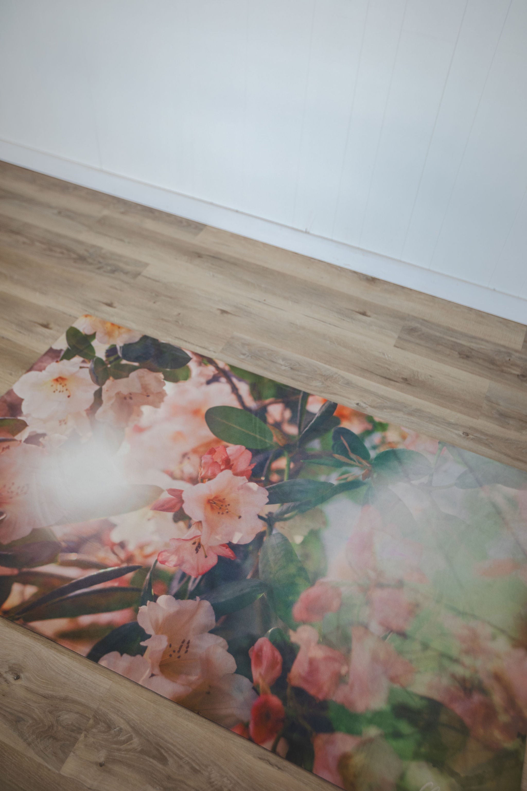 Floral-patterned mat on a wooden floor