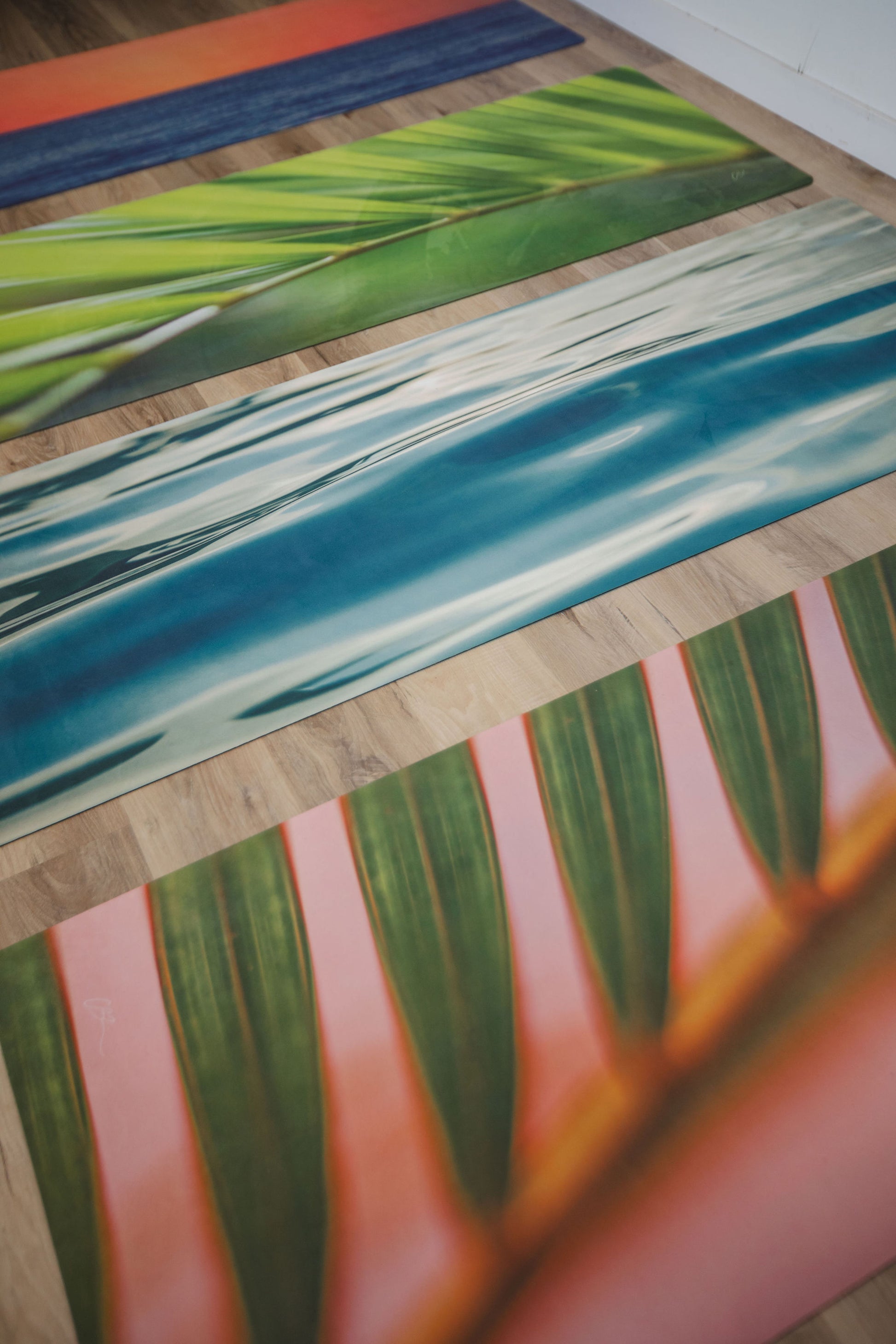 Colorful striped rug mat for yoga with leaf patterns on a wooden floor
