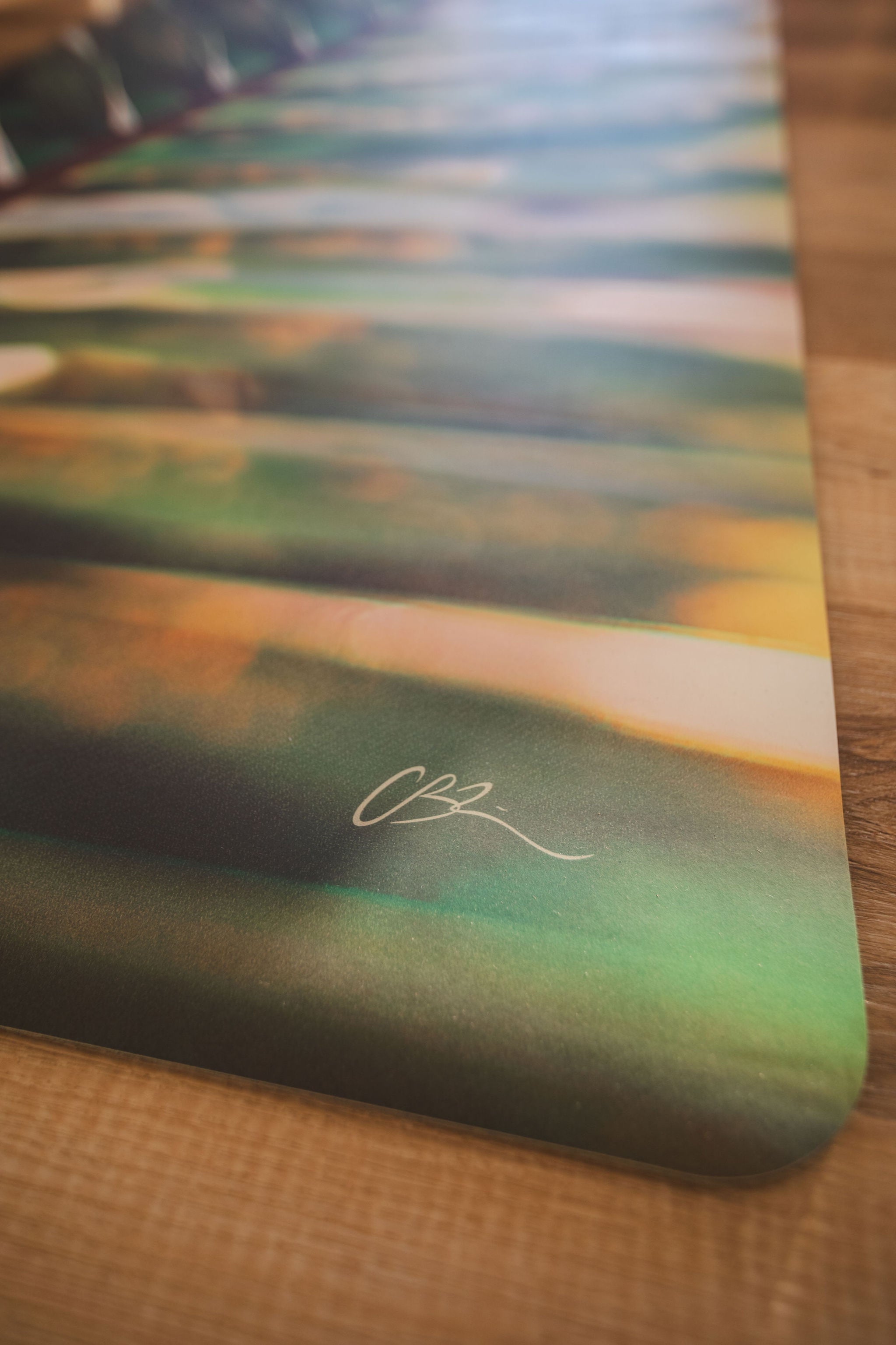 Colorful mat with a signature on a wooden surface