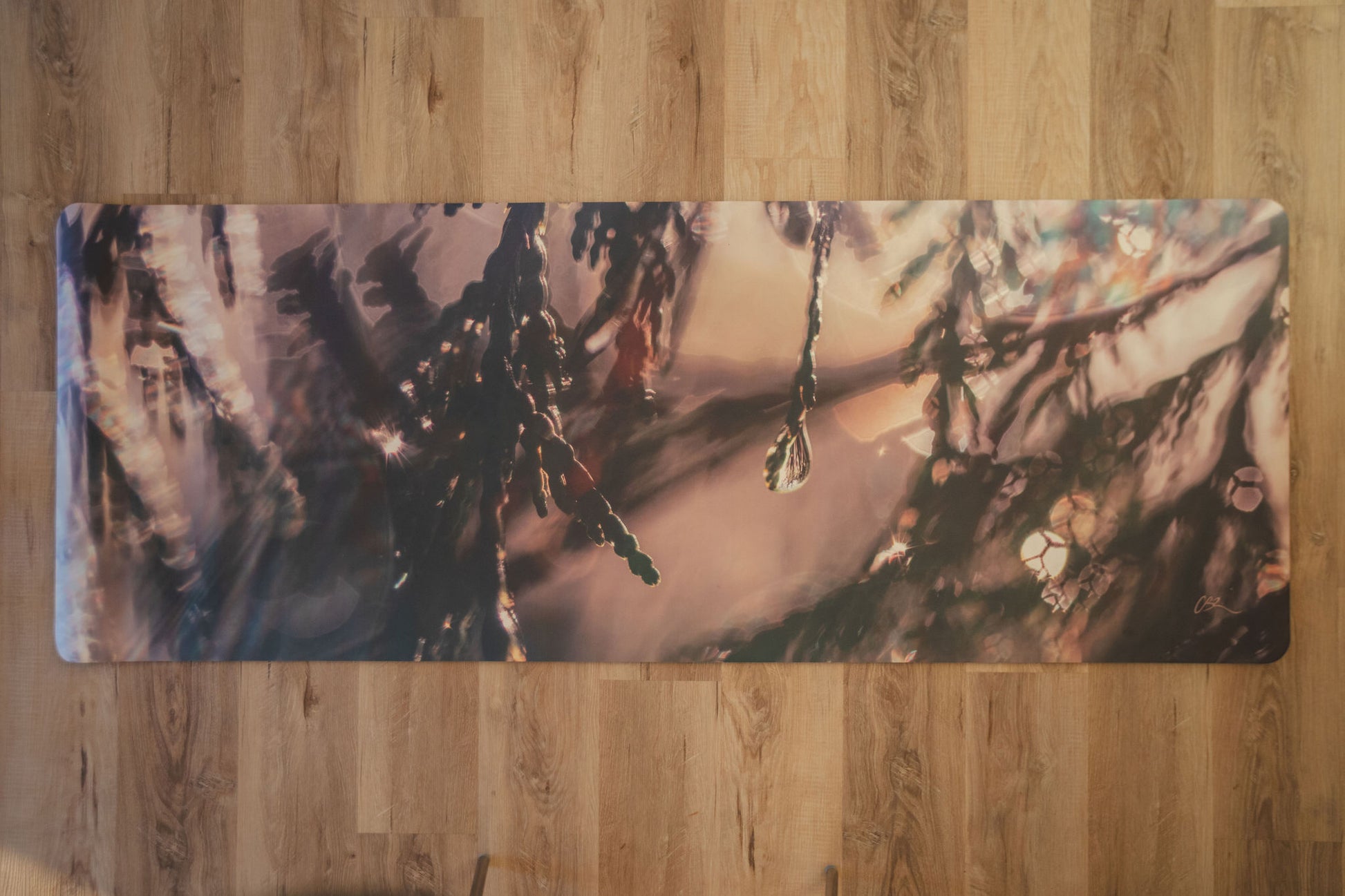 Yoga mat with nature-themed design on a wooden floor