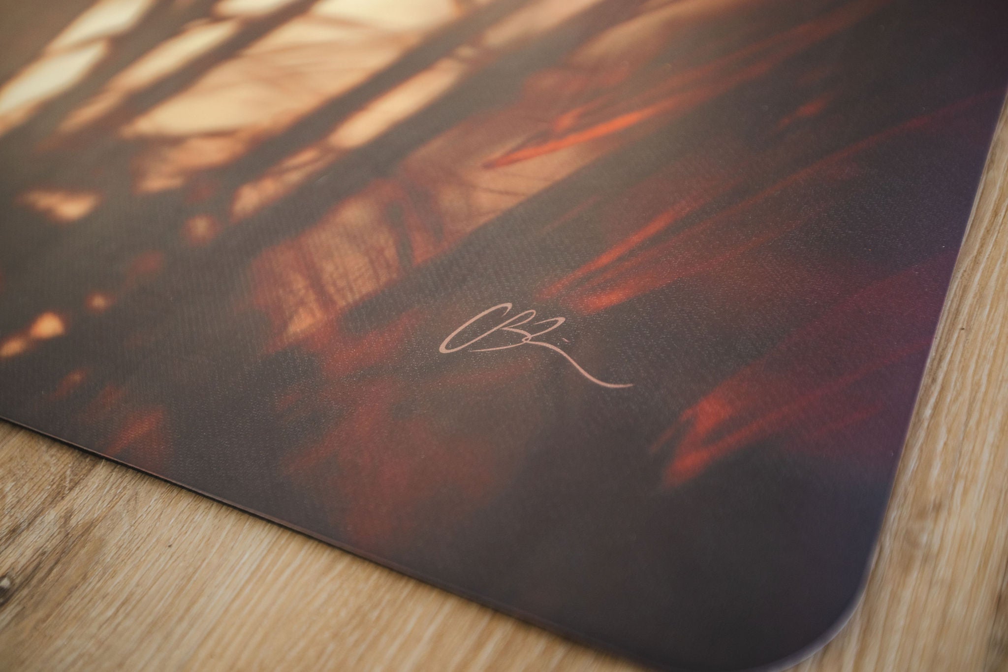 Yoga mat with palm leaf design on a wooden floor