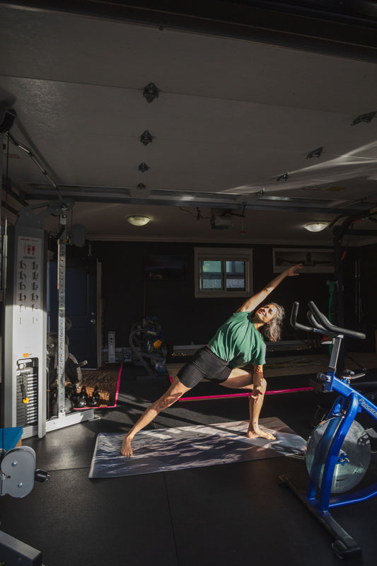 Person practicing yoga in a home gym setting